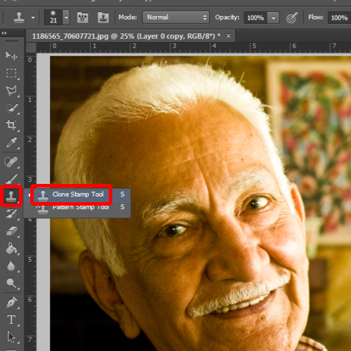 Use the clone stamp tool